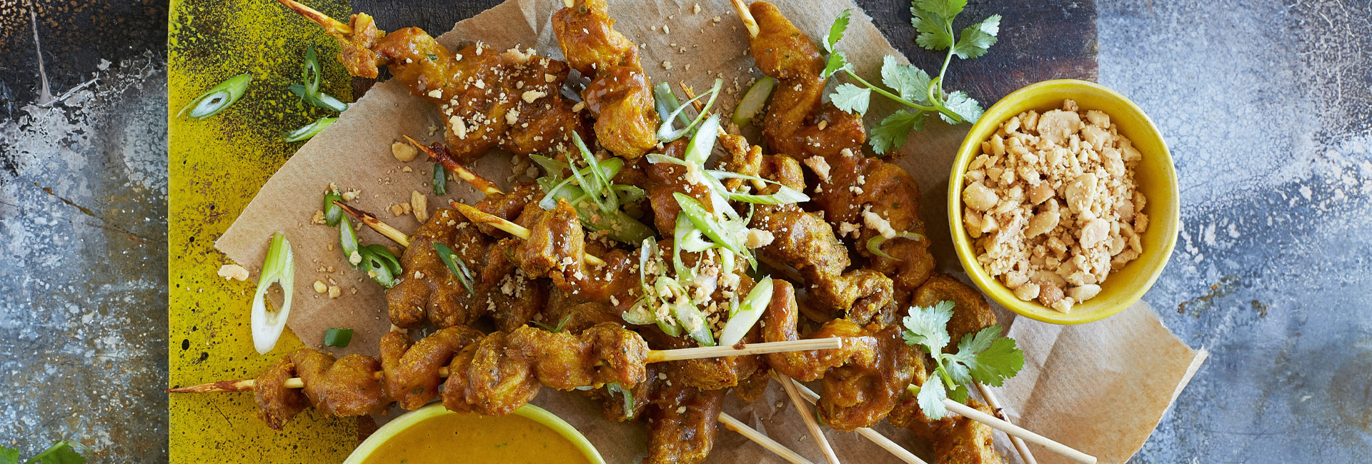 Chicken curry kebabs on platter with dipping sauces