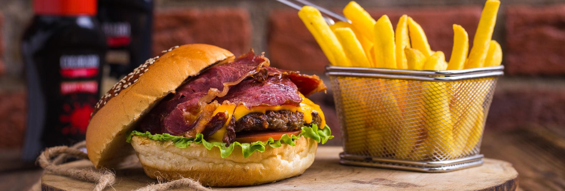 Burger and fries on a wooden board