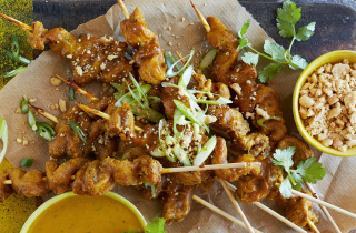 Chicken curry kebabs on platter with dipping sauces