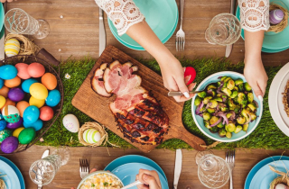 Table laid for Easter with different dishes and coloured Easter eggs
