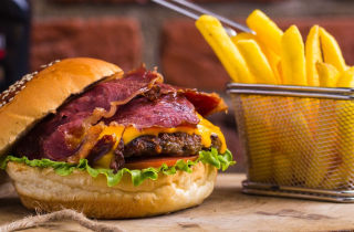 Burger and fries on a wooden board